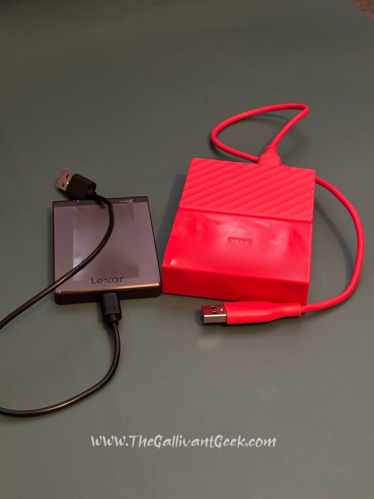 Lexar portable SSD and red WD 1 TB portable hard drive used for photo backups
