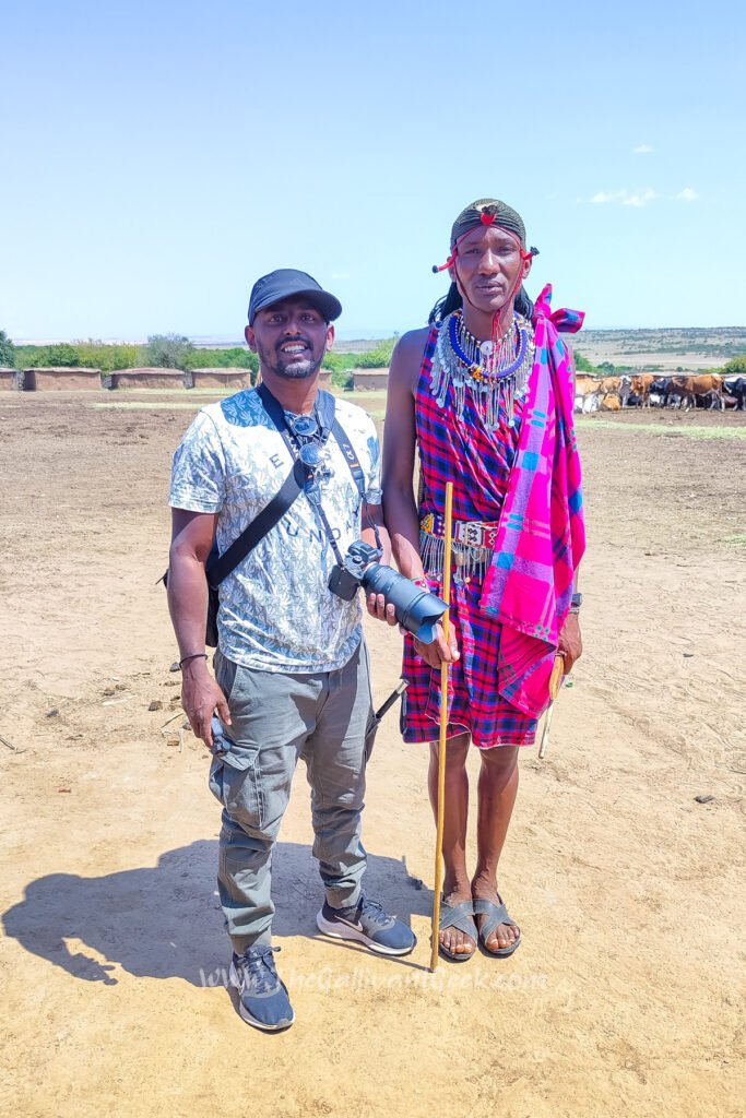Standing with a Maasai man in a village in the Masai Mara
