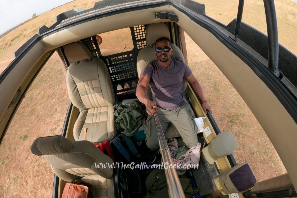 GoPro wide-angle view of a photographer inside an open-roof safari vehicle in Kenya