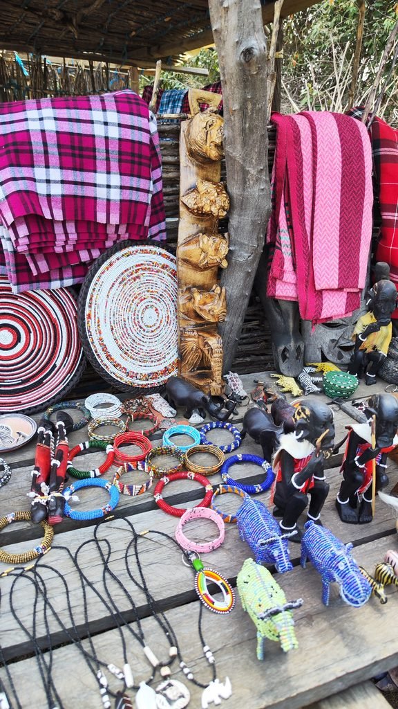 Shukas, bowls and beaded jewellery at a Maasai village souvenir market